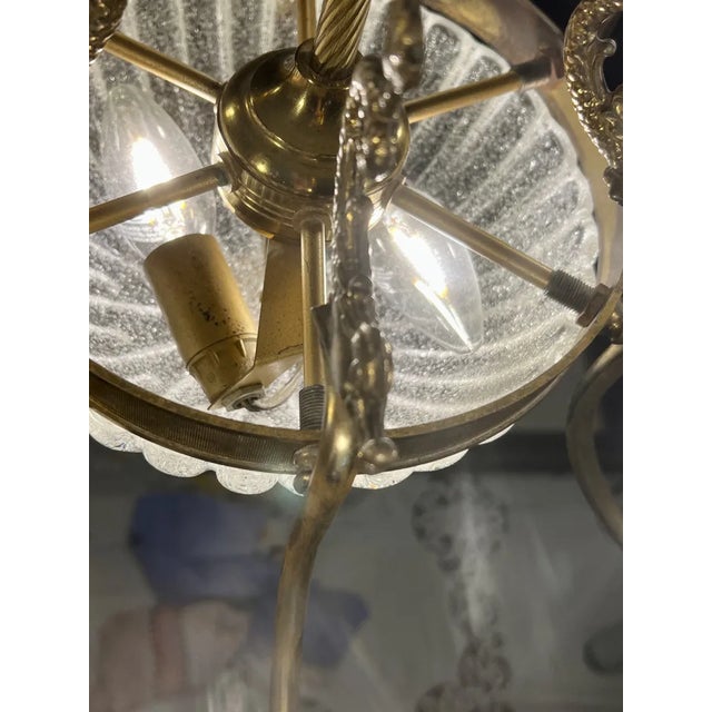 The chandelier offered here appears to be a transitional production between Art Nouveau and Art Deco, as it still has some...