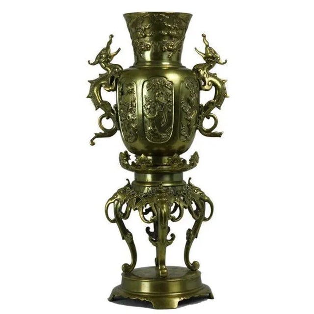 Chinese brass vase with 2 dragon handles and a base. Made in the 1900s