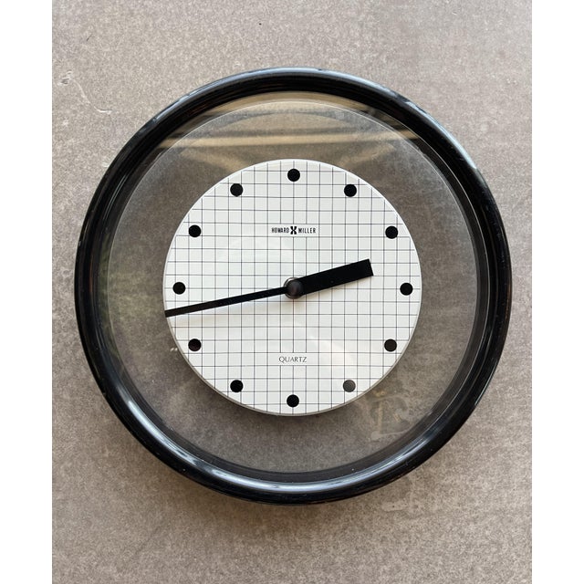 Postmodern, Memphis Design era Howard Miller clock with floating check face and black thick outer rim. Black hands and...