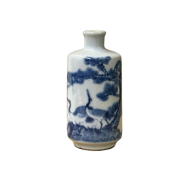 This charming 4.75" tall small porcelain vase features hand-painted blue and white scenery graphic artwork. The...