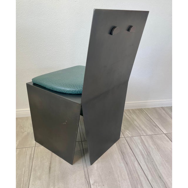 Beautiful from every vantage point, this architectural chair is crafted from heavy solid metal with a bronze finish....