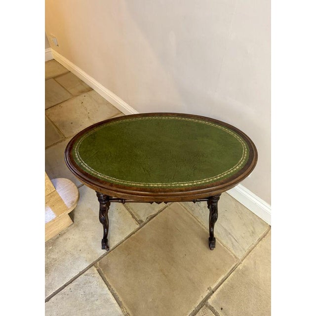 Fine quality antique Victorian walnut leather top oval writing table, having a quality oval walnut top with a gilt tooled...