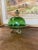 Vintage covered candy dish featuring a rich green glass dome lid and matching underplate, set on an ornate pedestal base...