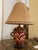 Brighten your space with the charming elegance of this vintage floral lamp. Featuring a vibrant red base adorned with...