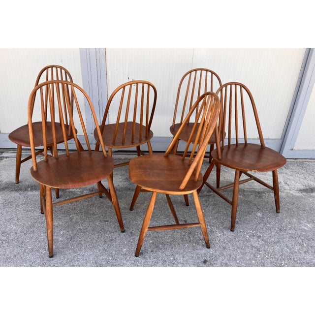 This set of six dining chairs is the Quaker model designed by Lucian Ercolani for Ercol in the 1960s, made of wood with...