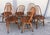 This set of six dining chairs is the Quaker model designed by Lucian Ercolani for Ercol in the 1960s, made of wood with...