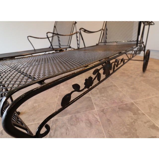 A refined pair of vintage wrought iron chaise loungers by the Sam Blount Company. These pieces feature a sculpted floral...