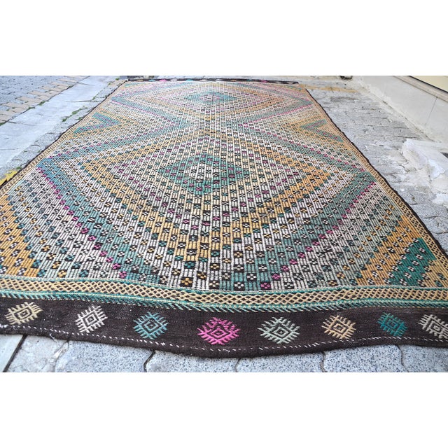 This is a vintage Turkish Anatolian kilim rug from the 1960s. The piece was hand-woven.