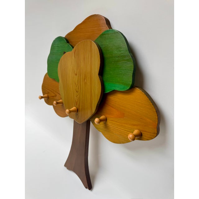 Vintage handmade wooden wall rack shaped like a wonderfully stylized tree, with layered sections of stained pine creating...
