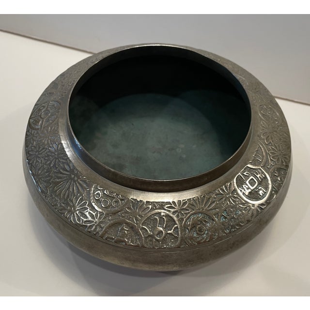 Center bowl of Asian origin, probably made of brass, but possibly bronze as it weighs almost 2 lbs. Raised lip over a...