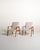 A pair of Scandinavian armchairs from the 1950s and 1960s with a solid teak frame and padded seat and backrest,...