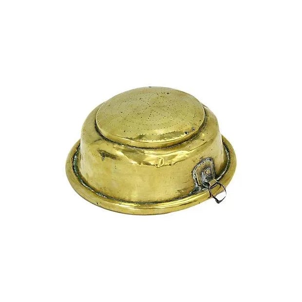 Antique French brass strainer with star pattern interior. Exterior loop for hanging. Possible from a dairy. No maker's mark.