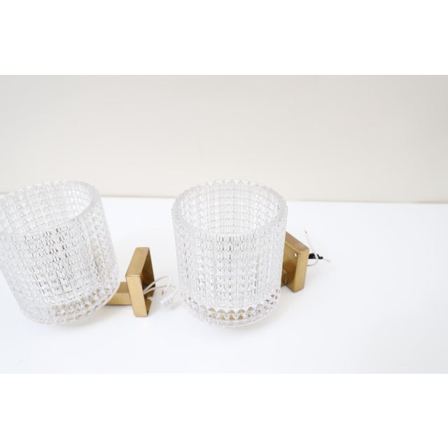 Elegant pair of sconces by carl Fagerlund for Orrefors made in Sweden around 1960, diamond cut cast glass mounted on...