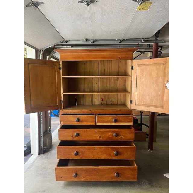 Beautiful English pine linen press with the original rosewood knobs and golden honey patina. Dated circa 1840, this linen...
