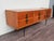 Large chest of drawers made in Italy in the 1950s. Teak veneer frame and metal legs with brass tips. It features clean...