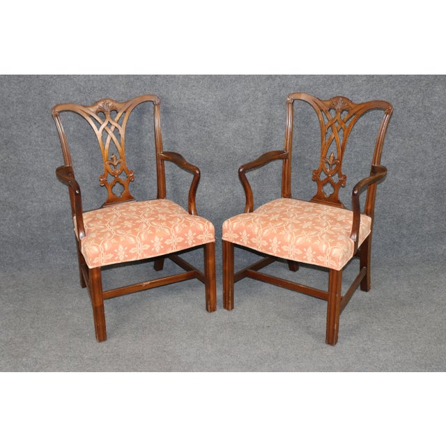 This handsome and extensive set of mahogany dining chairs, dating from the 1950s and executed in the Chippendale Georgian...