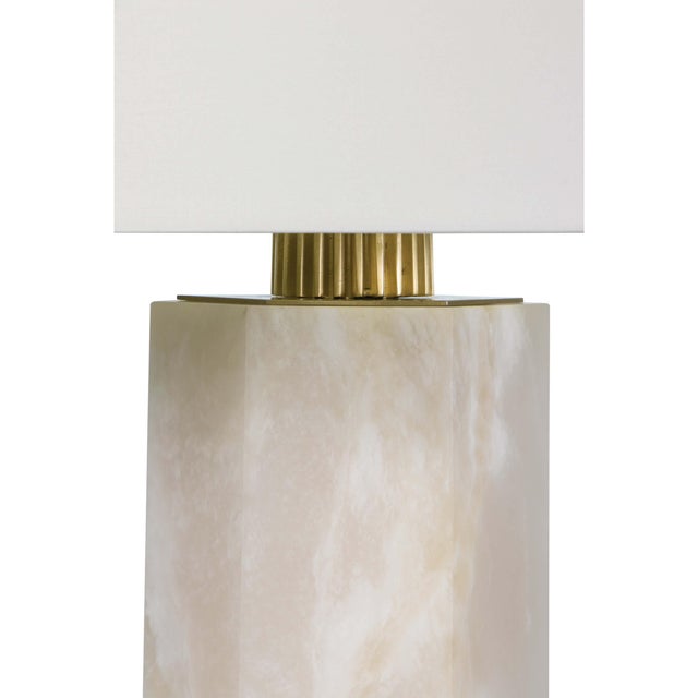The balanced geometry of a hexagon, extended into a modern column light. Our Gear alabaster table lamp sophisticated...