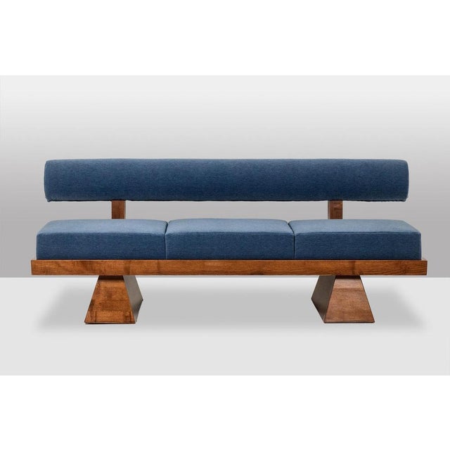 A 3-seater bench in light ash, upholstered in glacier blue mohair velvet. The seat consists of 3 cushions housed in a box...