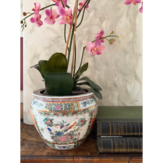 This is a vintage Chinese export porcelain fishbowl jardiniere featuring traditional Mandarin court scenes, floral panels,...