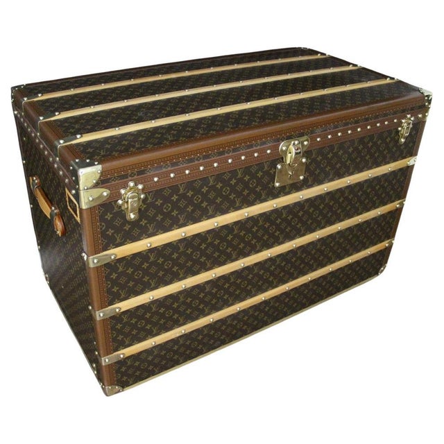 This stunning contemporary Louis Vuitton travel trunk is adorned with beautiful monogrammed canvas, honey-gold lozine...