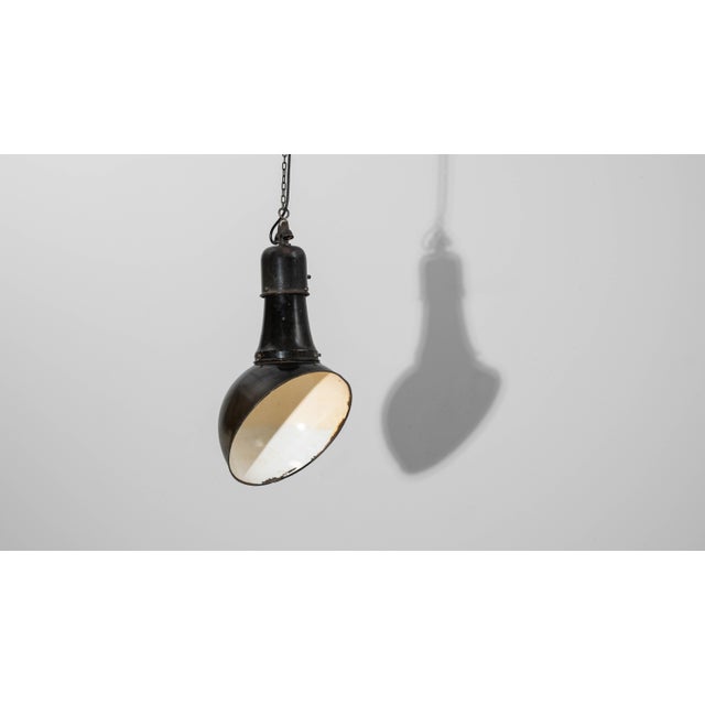 This 1930s Czech metal industrial angular pendant lamp embodies the functional aesthetics of early European factory...