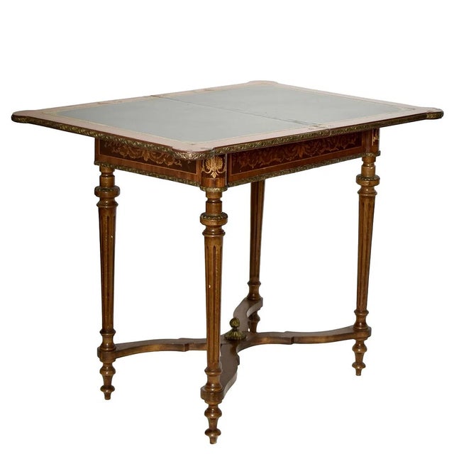The French Style Fold Over Game Table is a luxurious piece of furniture featuring a satinwood inlay with brass ware...