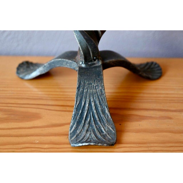 This large metal tripod candle holder or candlestick is crafted in a raw spirit. Equipped with a tripod base, its body...