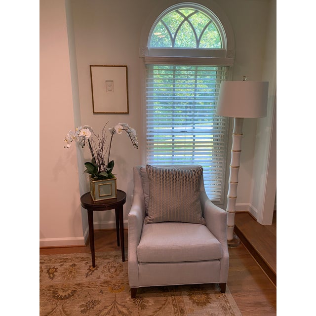 This Ryan Studio pillow features vertical blue dots on a tan background. The solid backed pillows are finished with blue...