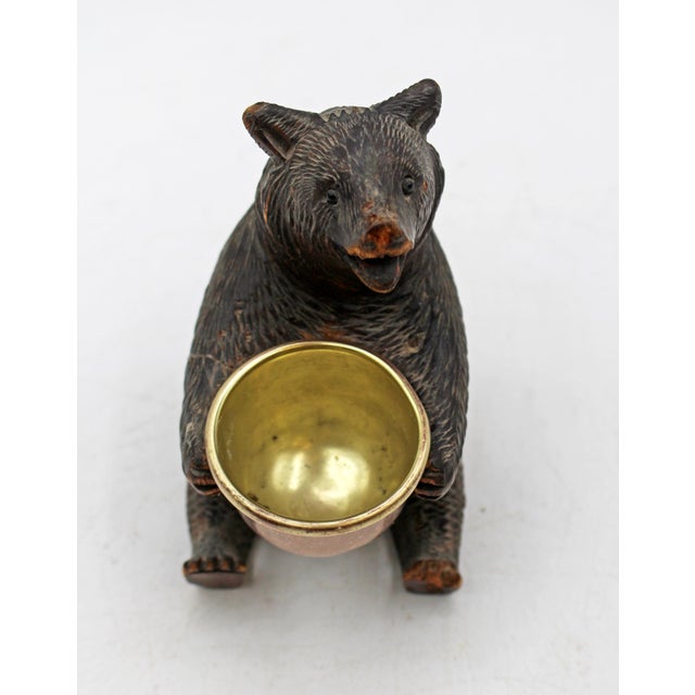 Late 19th century Black Forest seated bear with bowl, Swiss. Sweet seated bear holding a brass lined copper bowl for...