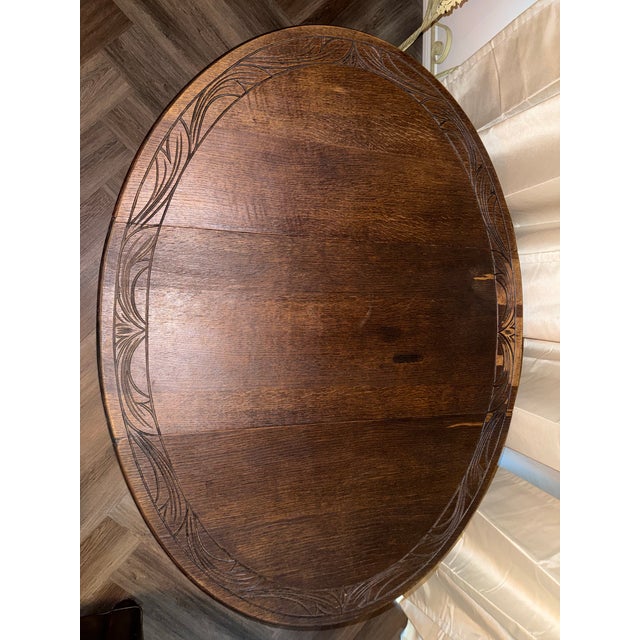 English oak drop-leaf gateleg table with barley twist (spiral-turned) legs, stretchers, and a gate mechanism that swings...