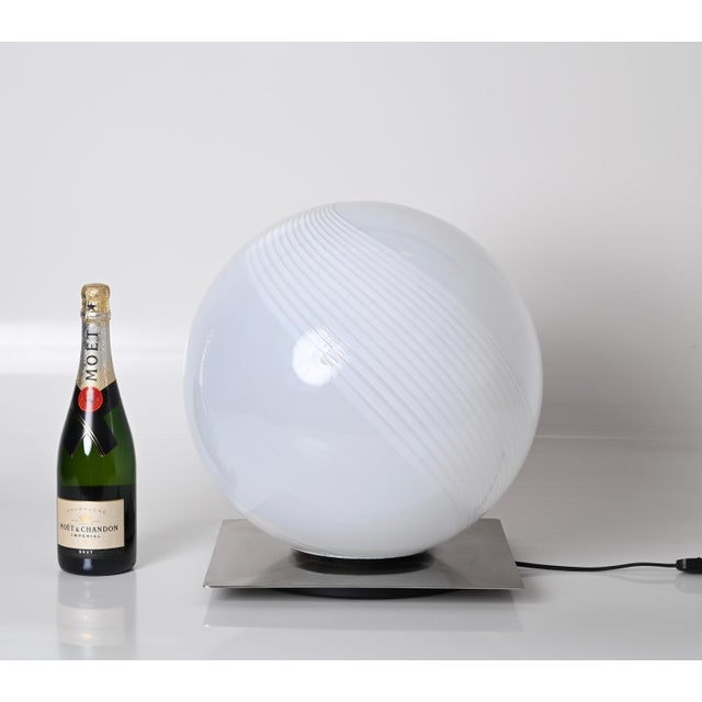 Stunning large table lamp in Murano encased glass with steel base. The lamp is signed on the bottom and was designed by...