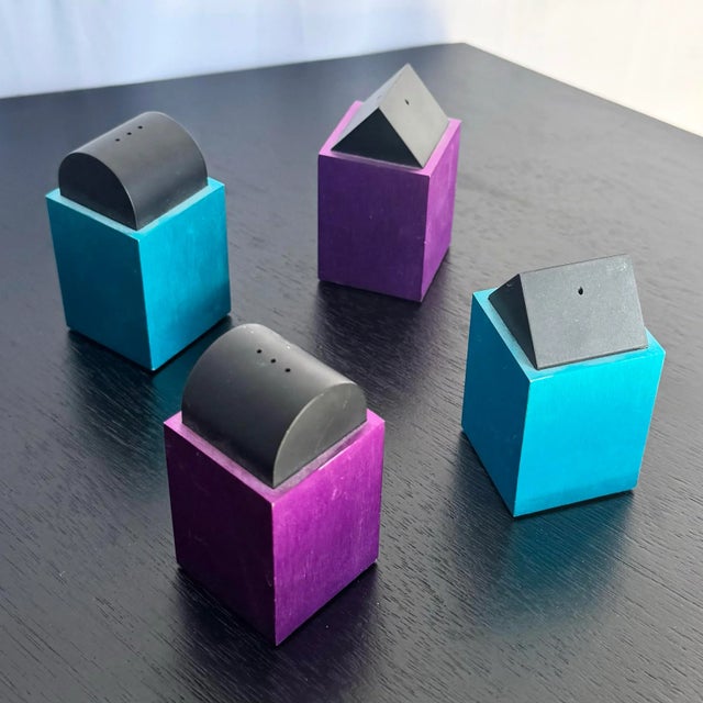A playful set of postmodern salt and pepper shakers designed by David Tisdale for Elika. Featuring geometric black tops on...