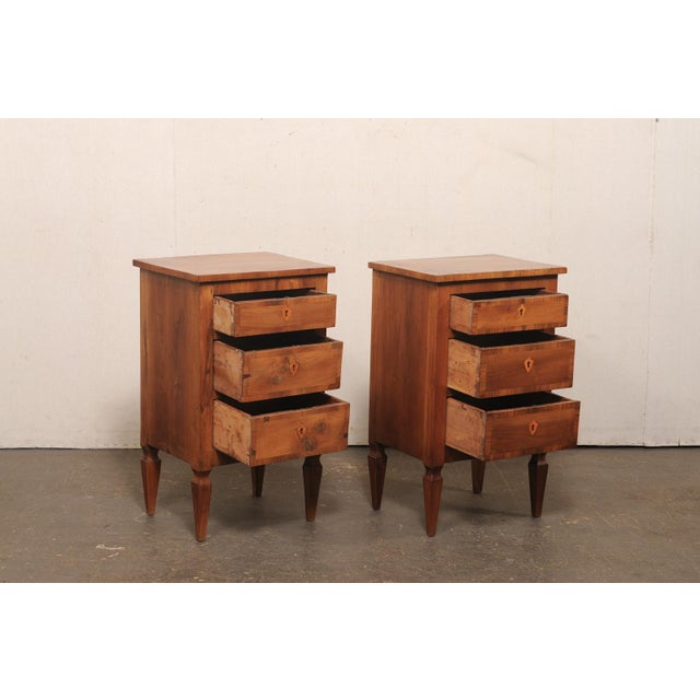 A handsome pair of petite Italian three-drawer side chests from the early 20th century. These antique chests from Italy...