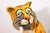 A mid-century modern papier mache sculpture depicting an endearing and delightful tiger by French artist and designer...