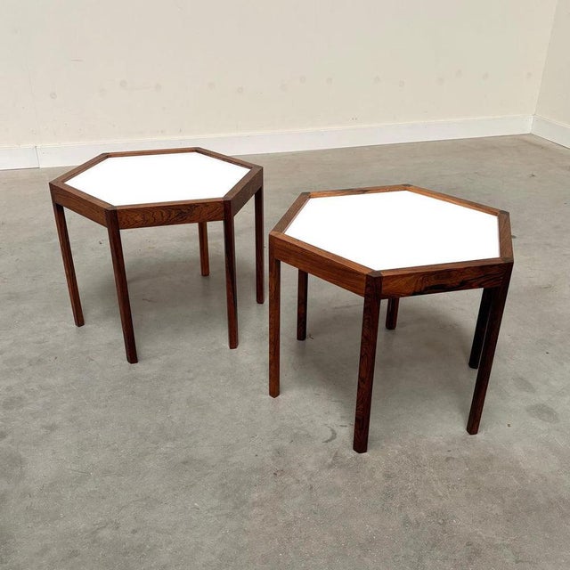 Remarks: Danish side tables by Hans Cristian Andersen, 1960s. Hexagon rosewood construction with formica table top. Both...