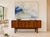 Mid Century Modern Teak Credenza by G-Plan, Made in England, c. 1960’s. This stunning piece combines generous storage with...