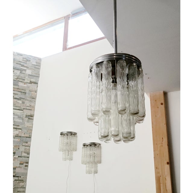 Magnificent and spectacular lighting set by Venini. Italy, 1970s. The chandelier features a chromed metal frame. Suspended...