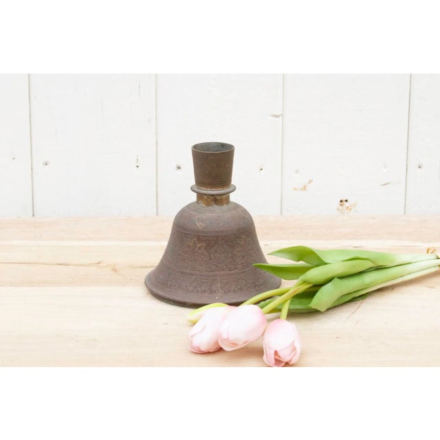 A lovely metal bell shaped flower base made from copper. This beautiful antique Indian candlestick holder is decorated...
