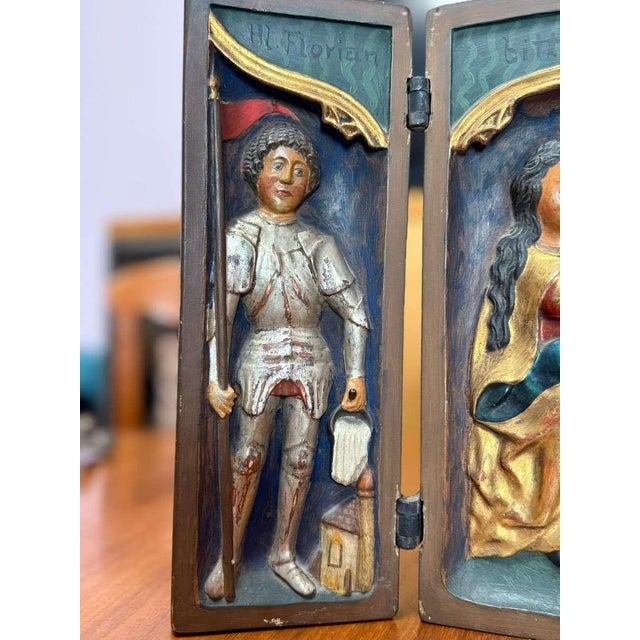 A striking Late Gothic triptych in high relief, carved in wood and richly polychromed with remnants of gilding. The...