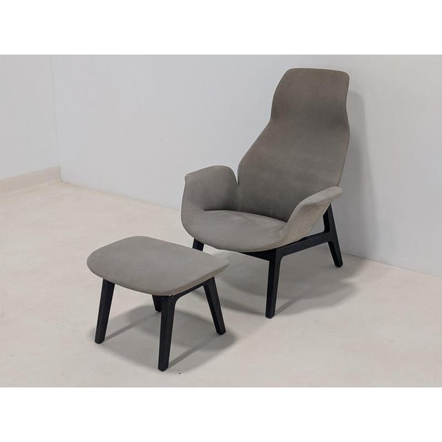 Designed with an ergonomic high-back profile, the armchair offers exceptional head and neck support, complemented by...