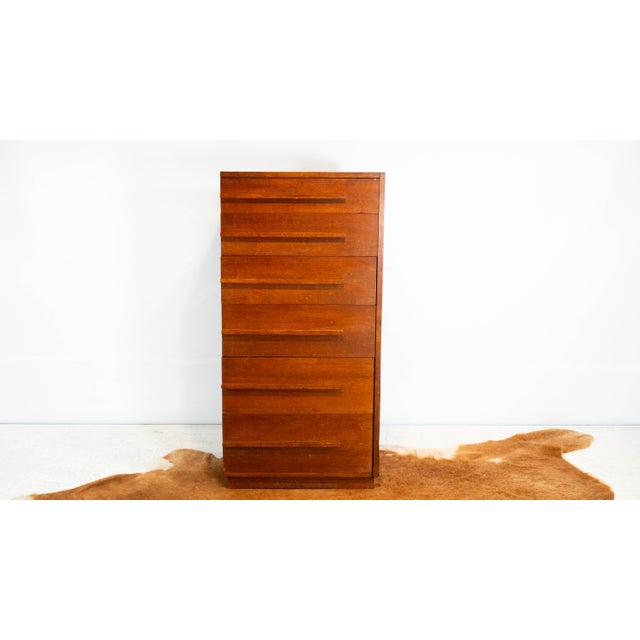 Vintage mid century teak highboy dresser, circa 1960s. Six drawers with long pulls and dowel joints. Unique asymmetrical...