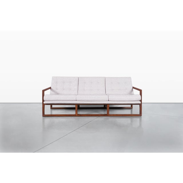 This exquisite vintage sofa, often attributed to the iconic designer Milo Baughman for Thayer Coggin, is a stunning...
