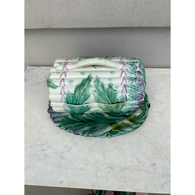 This French Majolica footed tureen is a bunch of asparagus surrounded by large artichoke leaves with his original under...