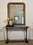 This antique French gilt mirror features a lovely aged patina, with intricate floral gilt detailing and beaded accents....
