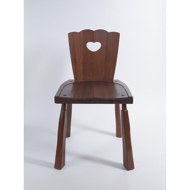 Artisan dining chair in sapele with carved edge detailing, designed and crafted by Valeriy Khvan. This chair is built from...