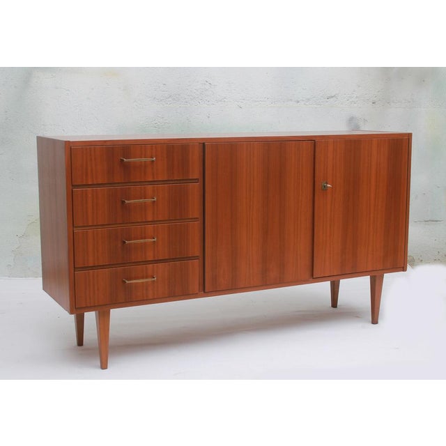 1960s sideboard, walnut veneer. Four drawers on the left. A double compartment on the right. Good condition with minor...