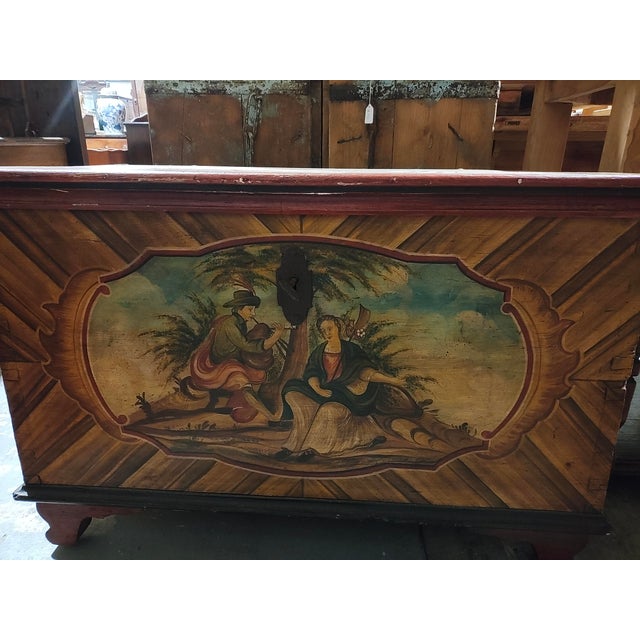 A charming mid-19th century Alpine blanket chest crafted from pine and richly decorated with hand-painted folk art panels...