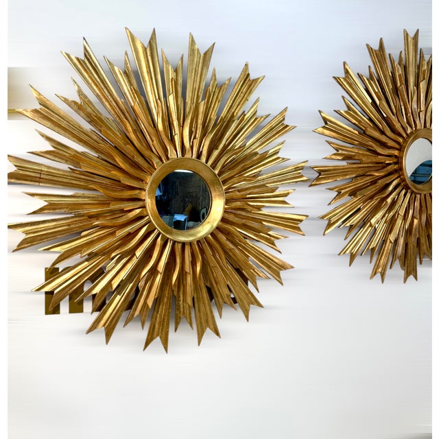 Set of 2 striking wall mirror features an elaborate sunburst design, with a circular central mirror surrounded by an array...
