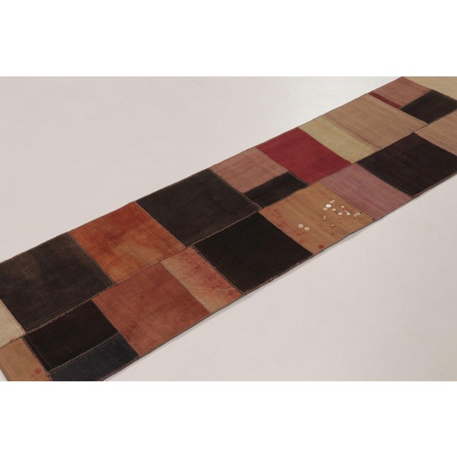Handwoven in wool and cotton and dating to circa 1950-1960, this vintage 2x8 Turkish kilim runner features a compelling...