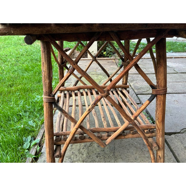 Adirondack lodge style handcrafted rustic twig accent table. Constructed from natural branches with a slatted top and...